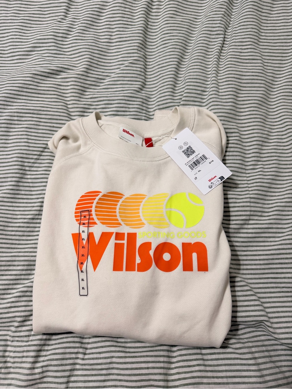 Wilson Women’s Cream Crewneck Sweatshirt with Orange Logo